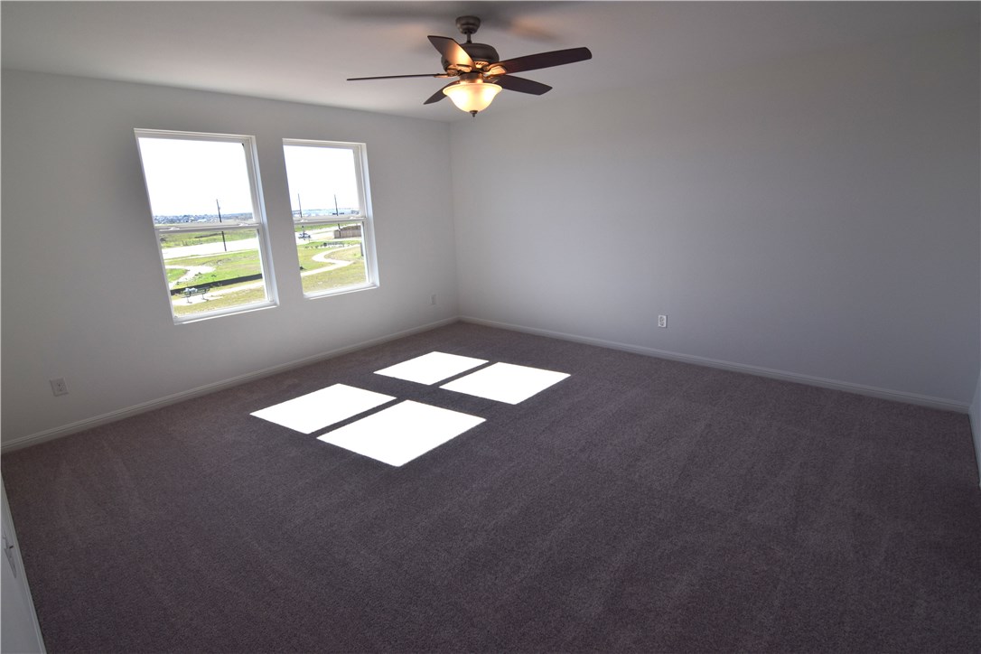 6705 Routenburn Street Austin, TX 78754 - Photo 9 of 18 an empty room with windows and fan