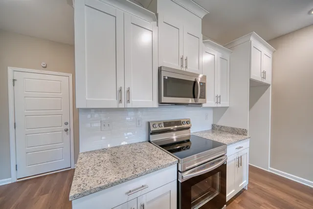 a kitchen with a sink and chandelier