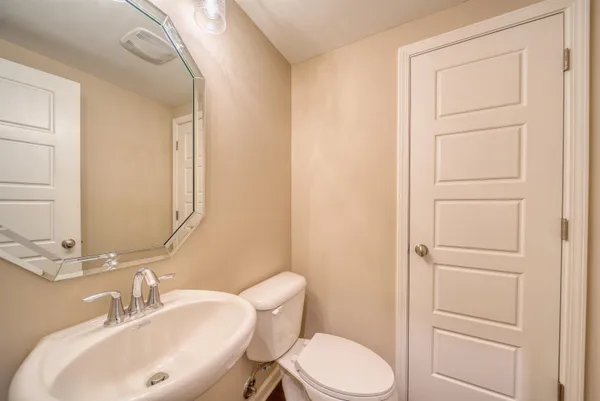 a kitchen with stainless steel appliances granite countertop white cabinets and a stove top oven