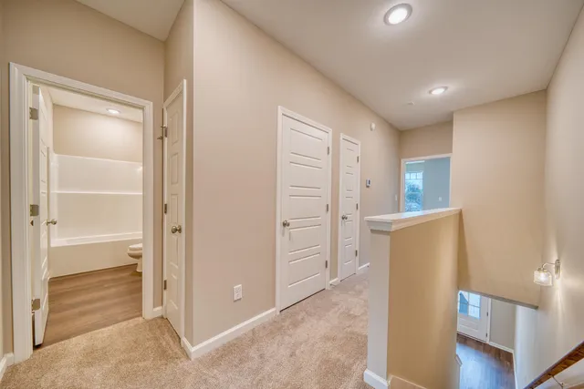 a view of a room with wooden floor and a window