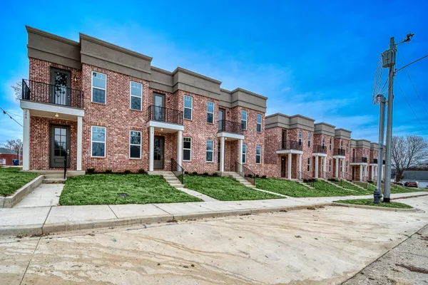 a front view of a building with garden
