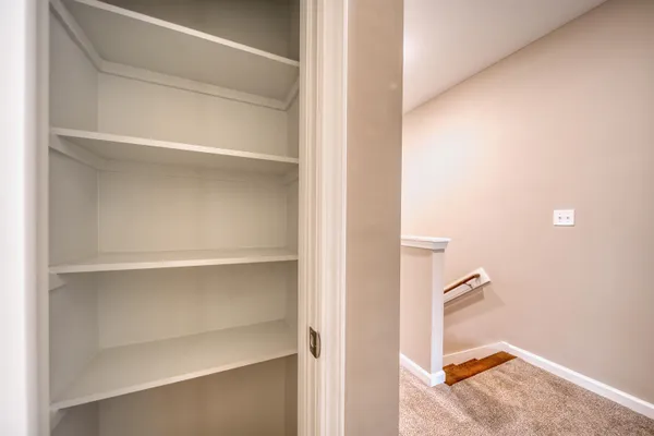 a view of a bathroom with washing machine and mirror