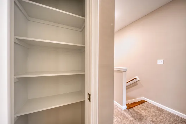 a view of a bathroom with washing machine and mirror