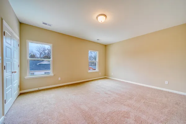 a bathroom with a granite countertop sink a toilet and bathtub