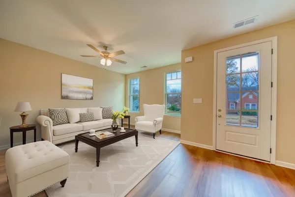 a living room with furniture and wooden floor
