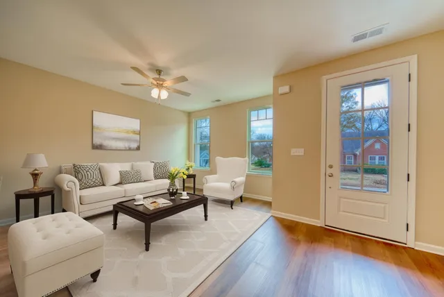 a living room with furniture and wooden floor