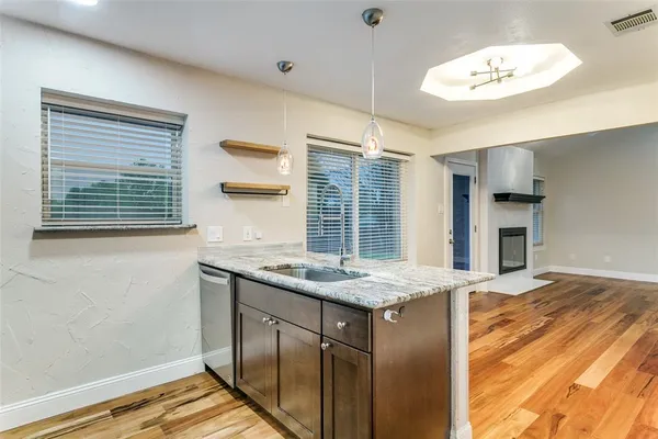 a kitchen with a sink stove and refrigerator