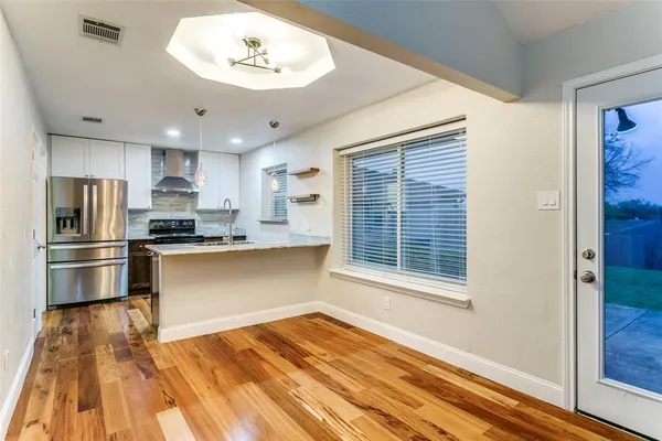 a kitchen with granite countertop a refrigerator and a stove