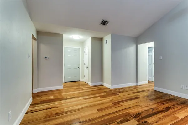 a view of a room with wooden floor and bathroom