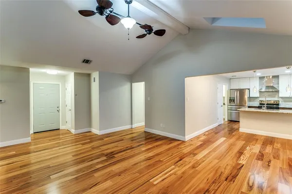 a view of a kitchen with wooden floor