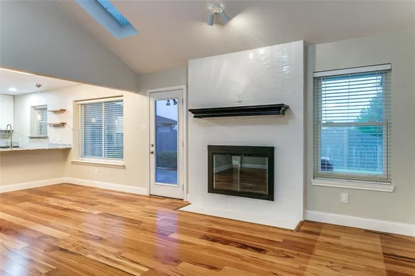 a view of an empty room with glass door and window