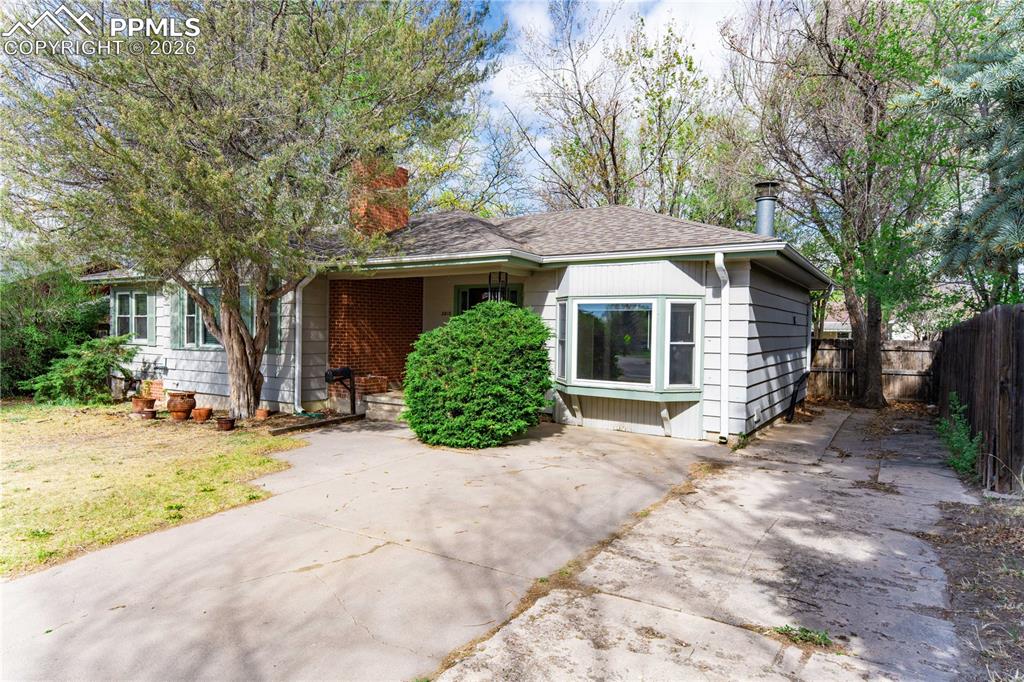 2818 Templeton Gap Road Colorado Springs, CO 80907 - Photo 1 of 27 a view of a house with a yard and large tree