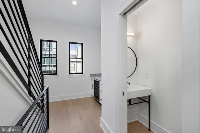 a living room with furniture potted plant and white walls