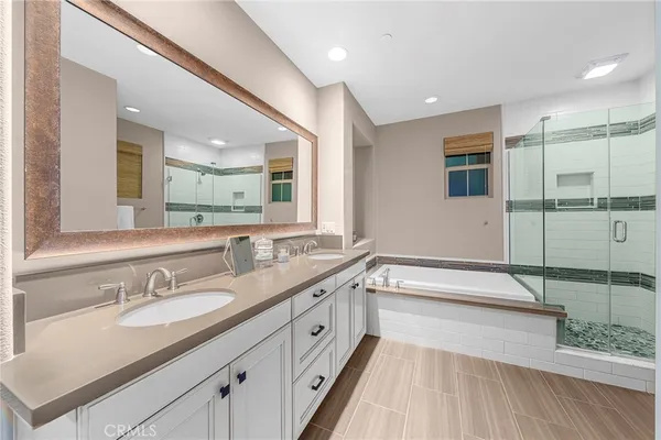 a spacious bathroom with a granite countertop sink mirror and bathtub
