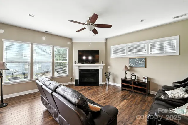a living room with furniture fireplace and a large window