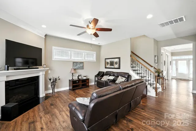 a living room with fireplace furniture and a flat screen tv