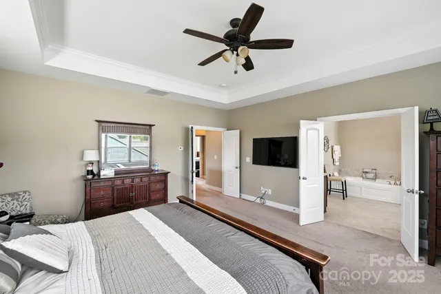a bedroom with a bed and a large window with the outer view