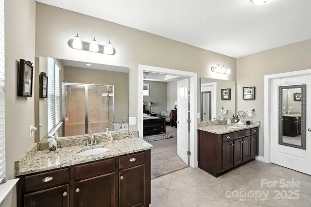 a spacious bathroom with a tub sink and mirror