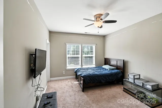 a bathroom with a sink a toilet and shower curtain