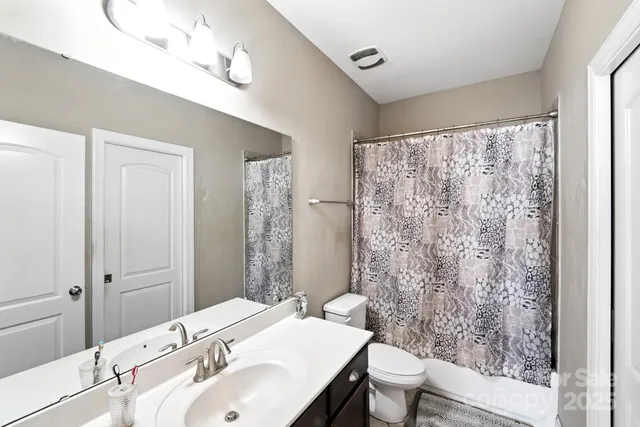 a view of a hallway with a livingroom and furniture