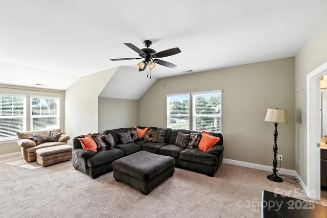 a view of a hallway with a livingroom and a bathroom with a sink