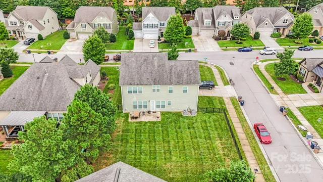 an aerial view of multiple houses with yard