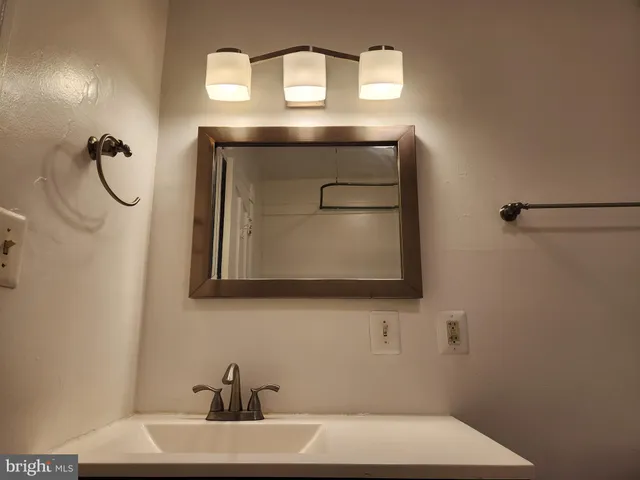 a bathroom with a sink a mirror and vanity