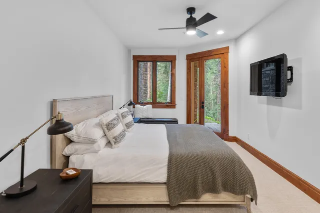 a bedroom with a bed and a chandelier