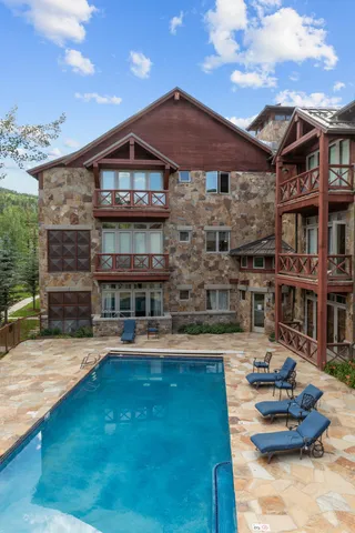 a swimming pool with outdoor seating and yard