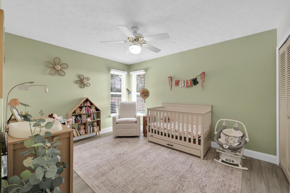 1950 Southwest Logwood Road Port St. Lucie, FL 34953 - Photo 19 of 32 a view of a bedroom with furniture and workspace