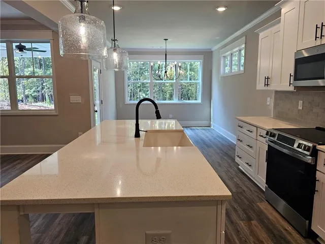 a view of a hallway with wooden floor and closet area