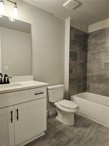 a front view of a house with a yard garden and outdoor seating