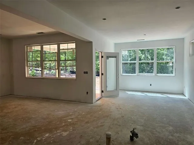 a view of kitchen with stainless steel appliances granite countertop a sink stove and refrigerator