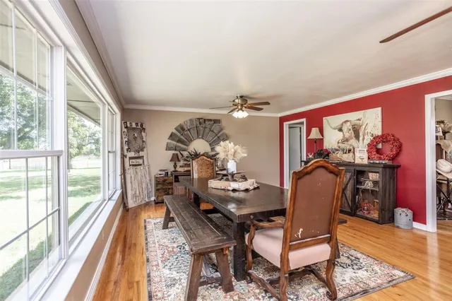 a dining room with furniture a rug and wooden floor