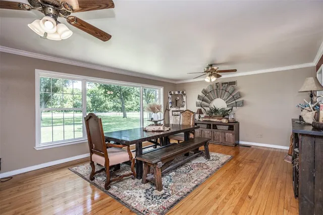 a living room with furniture a dining table and a large window