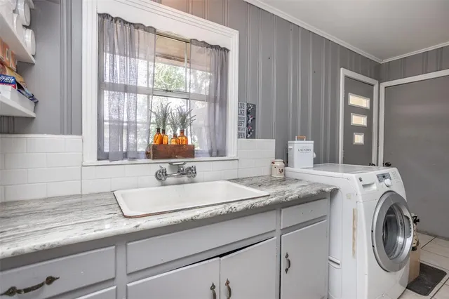 a bathroom with a sink and a washing machine