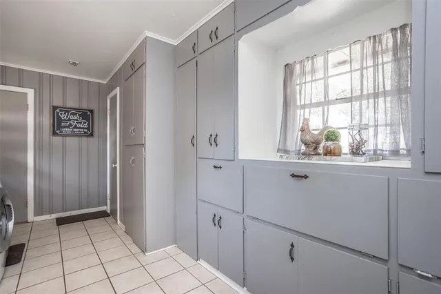 a view of an empty room with window and cabinet