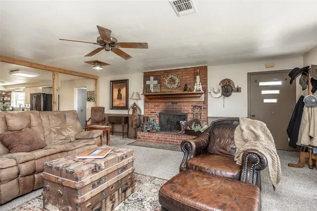 a living room with fireplace furniture and a flat screen tv