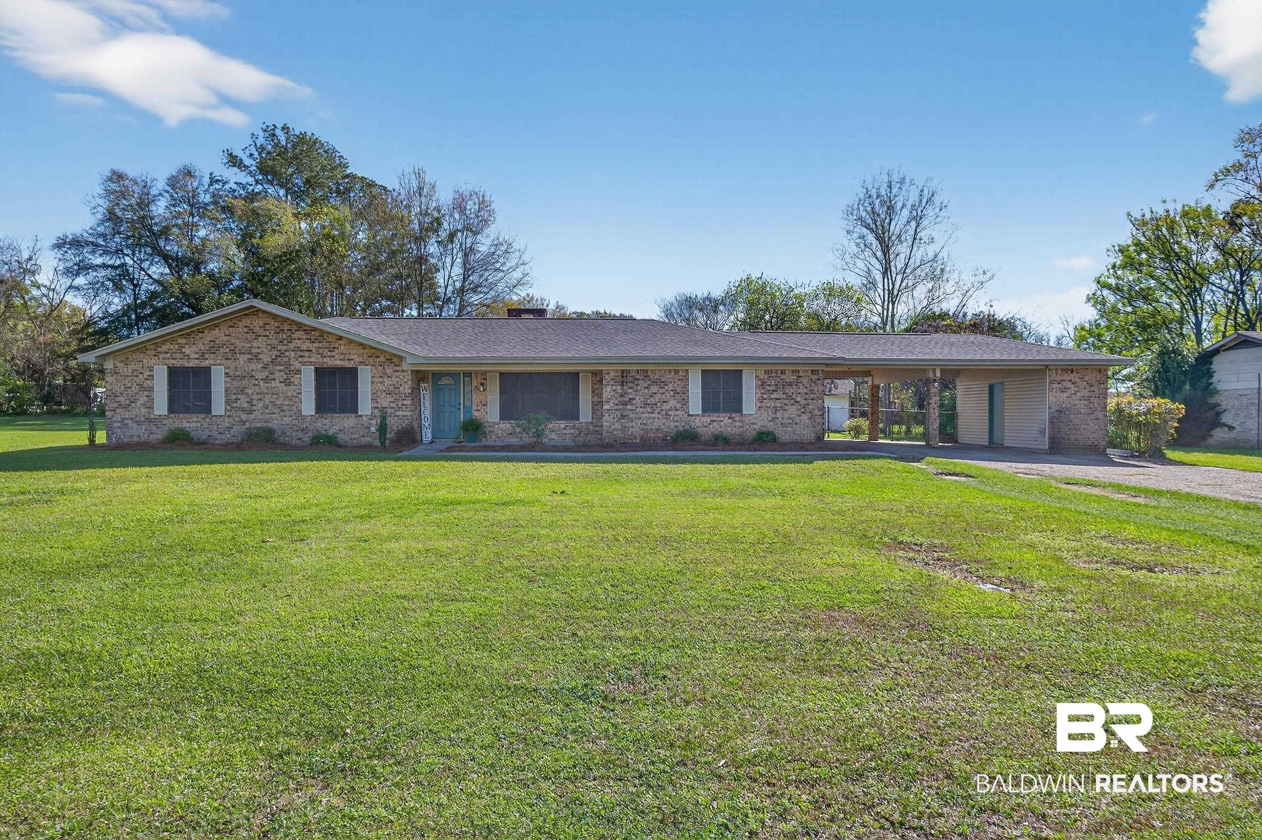 46006 Pecan Lane Bay Minette, AL 36507 - Photo 3 of 40 Single story home with brick siding, a front lawn, a chimney, and an attached carport