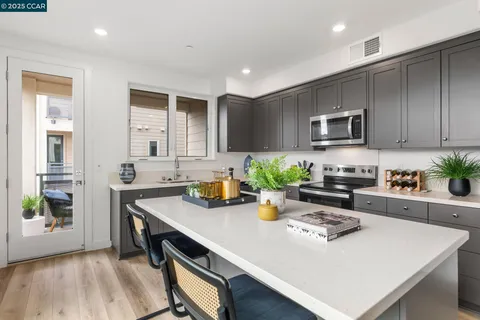 a kitchen with a sink a stove cabinets and counter space