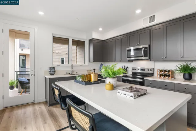 a kitchen with a sink a stove cabinets and counter space