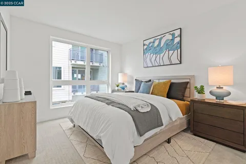 a bedroom with a bed and a painting on the wall