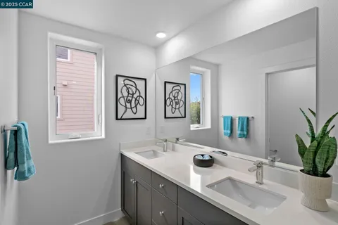 a bathroom with a double vanity sink and a mirror