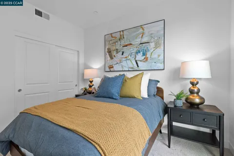 a bed room with a bed and a night stand