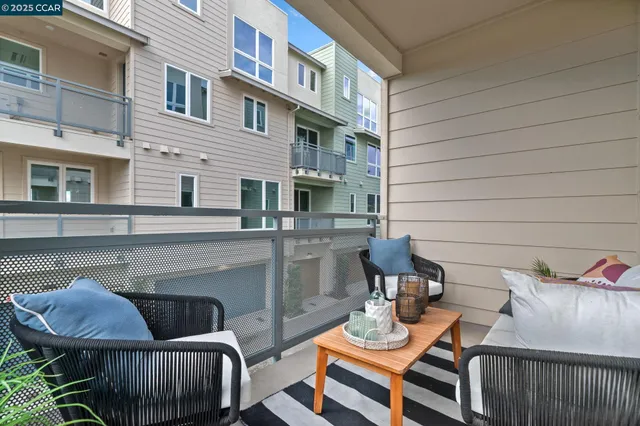a view of a patio with couches chairs and wooden floor