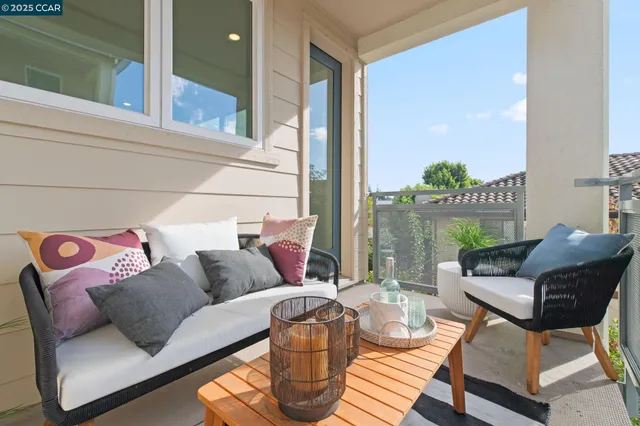 a living room with furniture and a floor to ceiling window