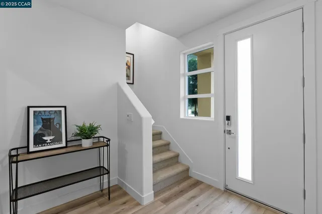 a view of entryway and hall with wooden floor