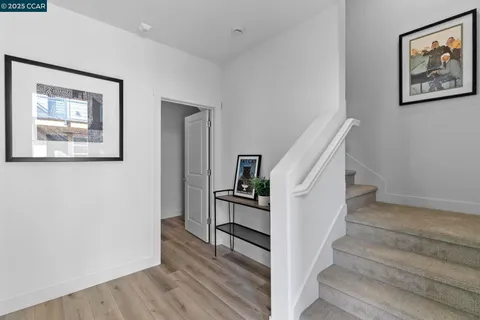a view of entryway and hall with wooden floor