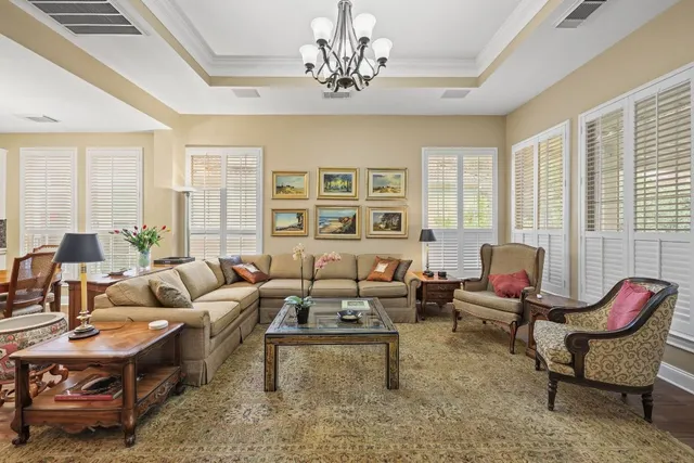 a living room with furniture or couch and a chandelier
