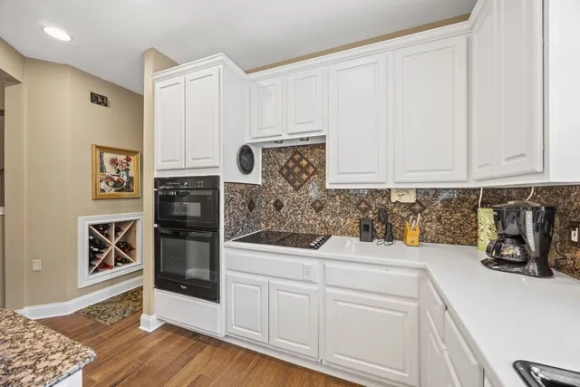 a spacious bedroom with a bed a couch and dresser